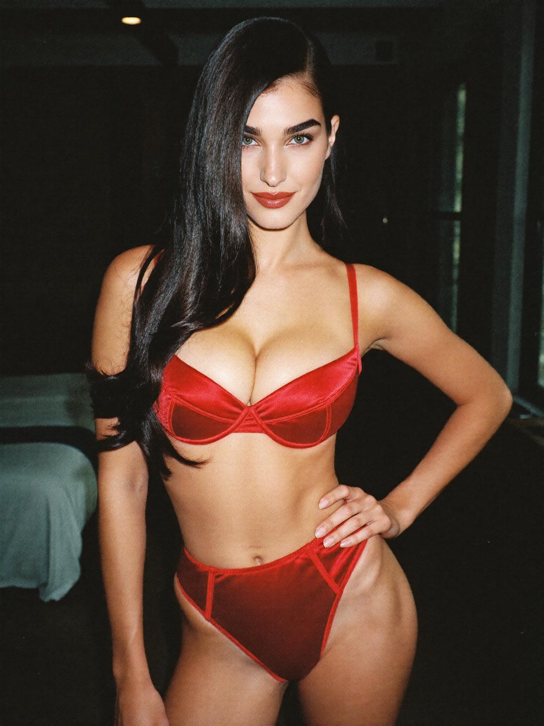 Ava in a red satin bra and briefs in a brick-walled New York loft
