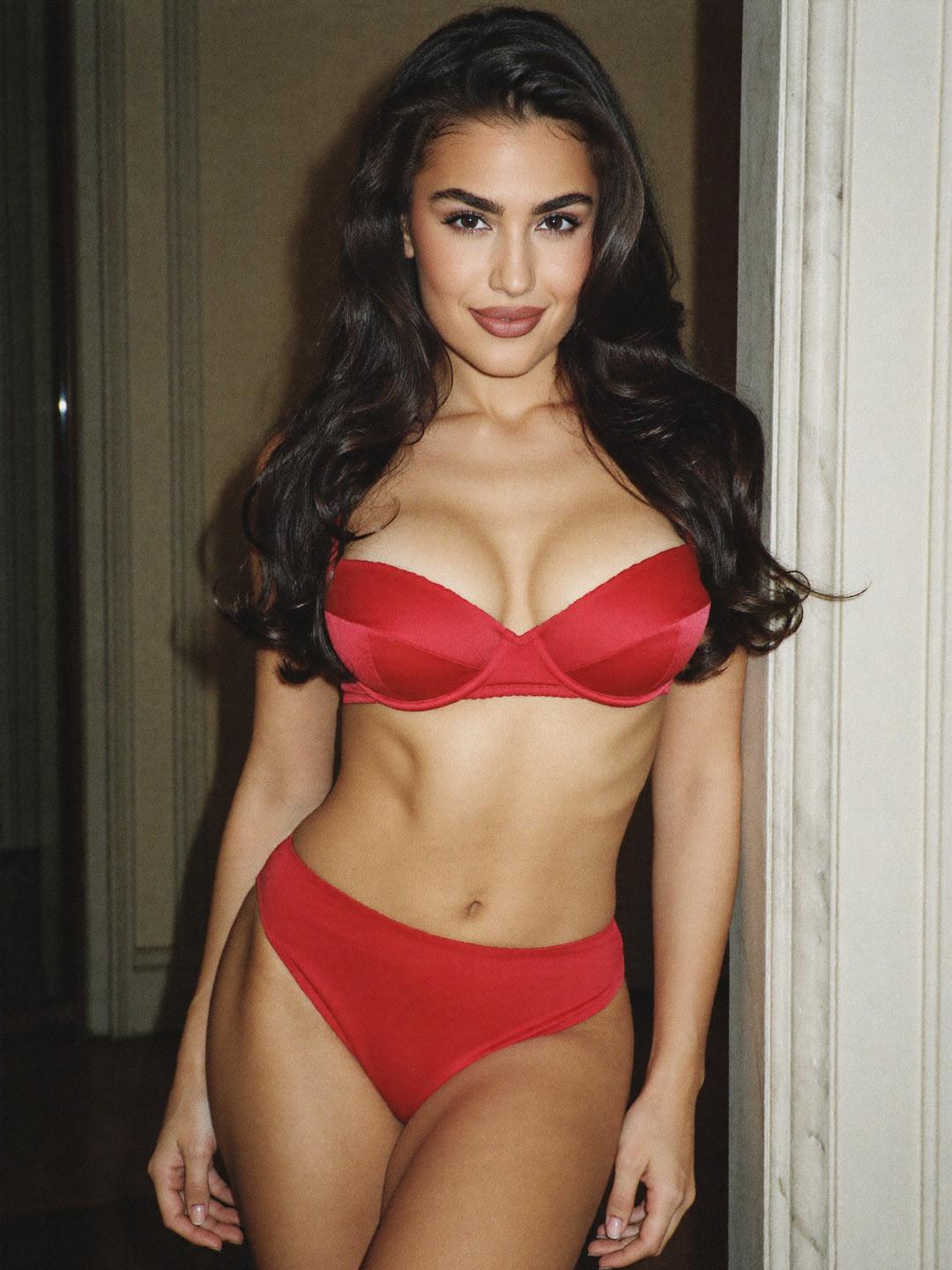 Giulia in red satin lingerie in a marble doorway of a Milan palazzo